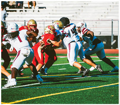 A football player wearing a blue and red jersey. Description generated by AI