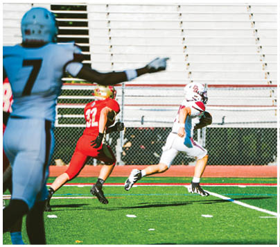 A football player wearing a blue and red jersey. Description generated by AI