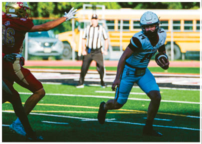 A football player wearing a blue and red jersey. Description generated by AI