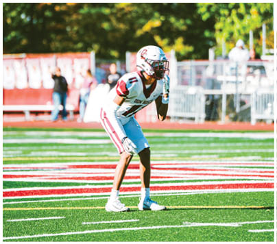 A football player wearing a blue and red jersey. Description generated by AI