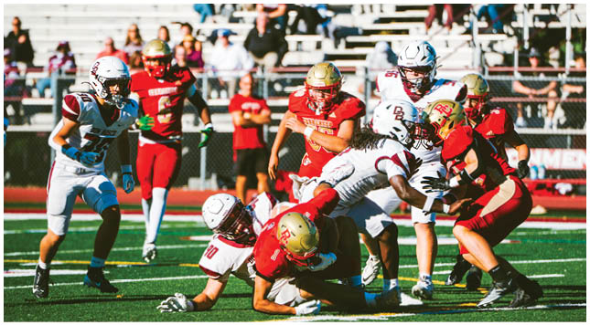 A football player wearing a blue and red jersey. Description generated by AI