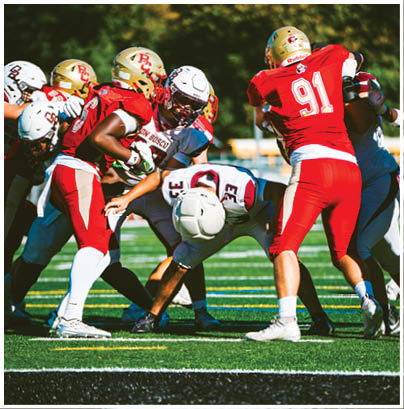 A football player wearing a blue and red jersey. Description generated by AI