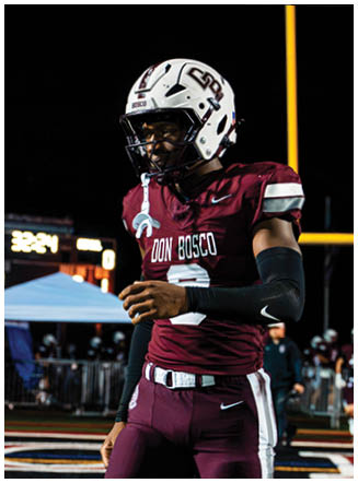 A football player wearing a blue and red jersey. Description generated by AI