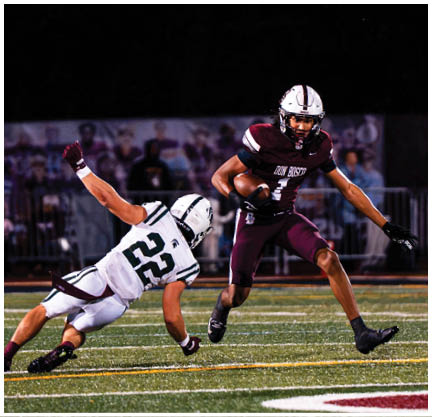A football player running on the field. Description generated by AI