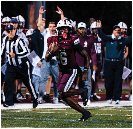 A football player running on the field. Description generated by AI