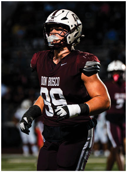 A football player wearing a blue jersey with the number 58 on it. Description generated by AI