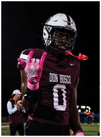 A football player wearing a blue and red jersey. Description generated by AI