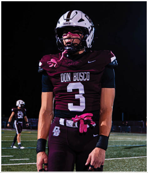 A football player wearing a blue and red jersey. Description generated by AI