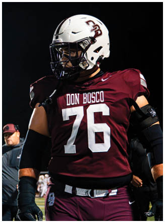 A football player wearing a blue and red jersey. Description generated by AI