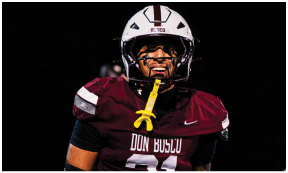 A football player wearing a blue and red jersey. Description generated by AI