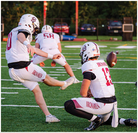 A football player wearing a blue and red jersey. Description generated by AI