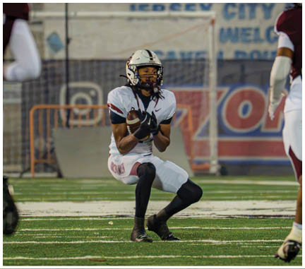 A football player running on the field. Description generated by AI
