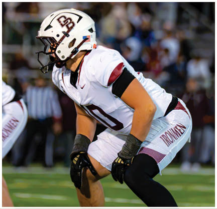 A football player running on the field. Description generated by AI