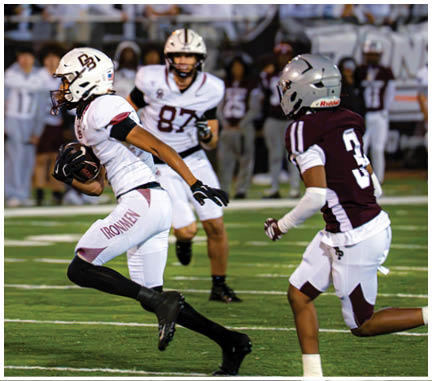 A football player running on the field. Description generated by AI