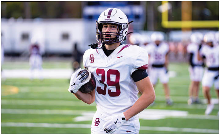 A football player wearing a blue and red jersey. Description generated by AI
