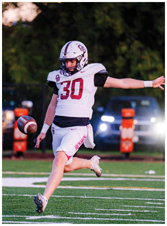 A football player wearing a blue and red jersey. Description generated by AI