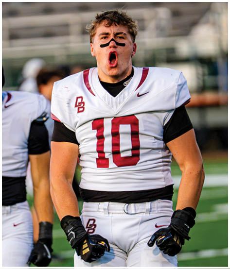 A football player wearing a blue and red jersey. Description generated by AI