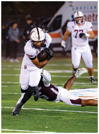 A football player wearing a blue and red jersey. Description generated by AI