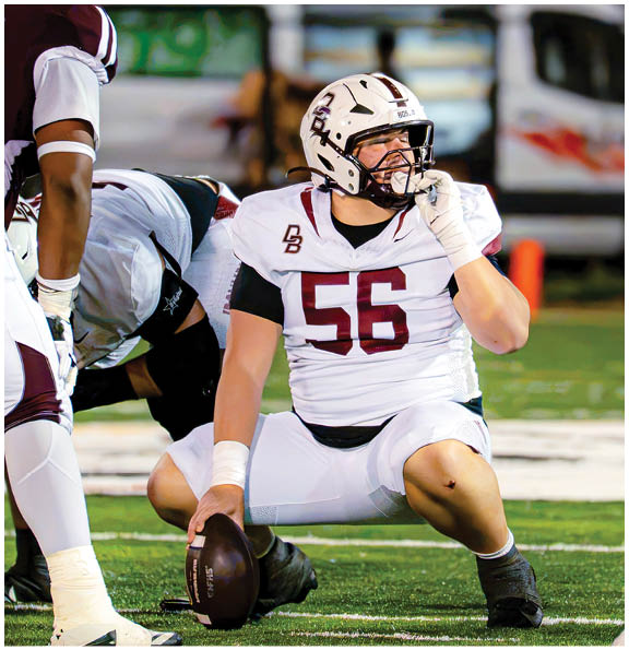 A football player wearing a blue and red jersey. Description generated by AI