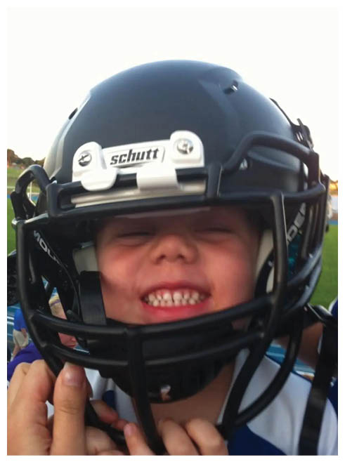 Two football players wearing black jerseys and holding hands. Description generated by AI