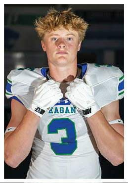 A football player wearing a blue and red jersey. Description generated by AI