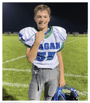 A football player wearing a blue and red jersey. Description generated by AI