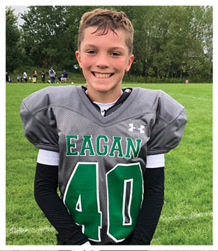 A football player wearing a blue and red jersey. Description generated by AI