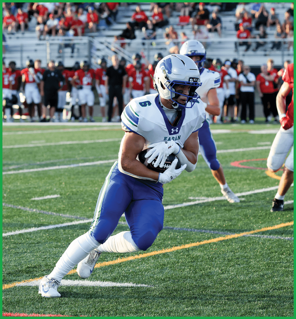 A football player in a white jersey with the number 16 on it. Description generated by AI