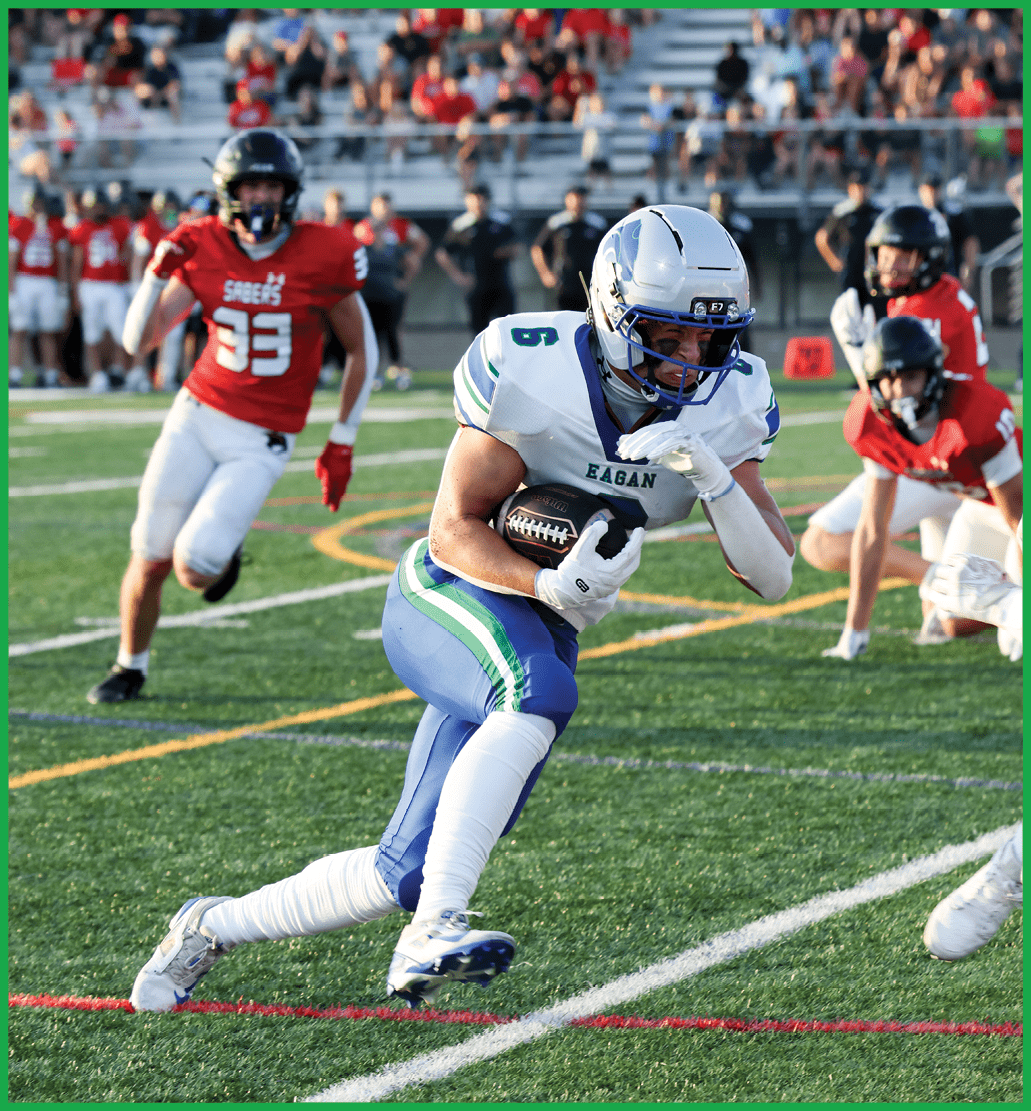 A football player running with a football. Description generated by AI
