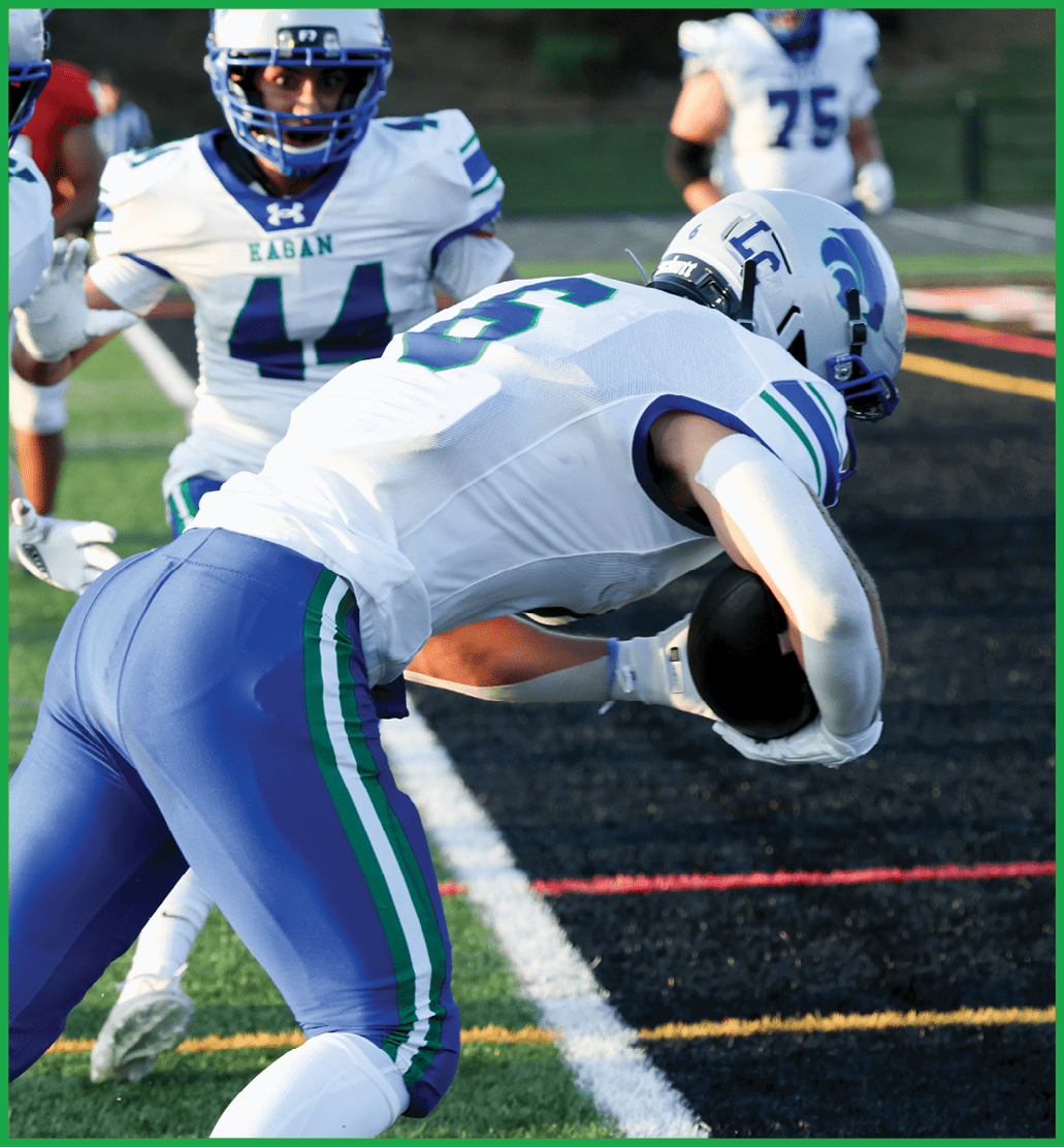 A football player running on the field. Description generated by AI