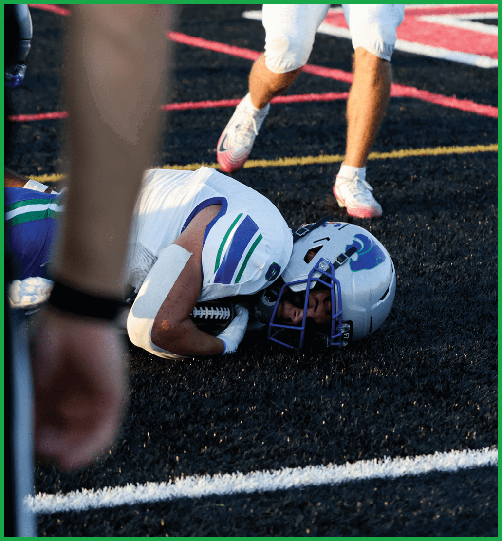 A football player running on the field. Description generated by AI