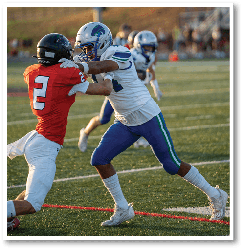 Two football players wearing black jerseys with the number 11 on them. Description generated by AI