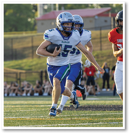 A football player wearing a black jersey with the number 6 on it. Description generated by AI