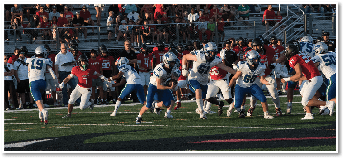 A group of football players on a field. Description generated by AI