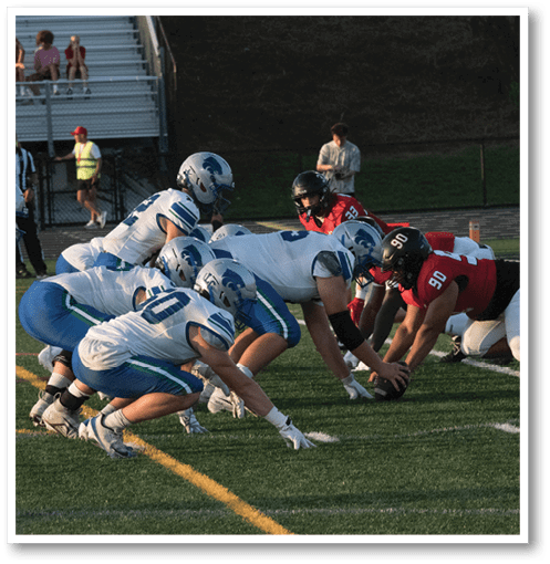 A group of men wearing black and white jerseys. Description generated by AI
