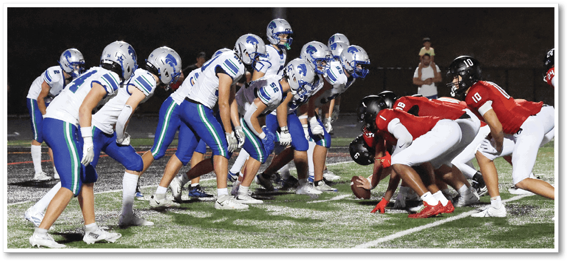 A group of football players on a field. Description generated by AI