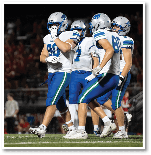 A group of men wearing black and white jerseys. Description generated by AI