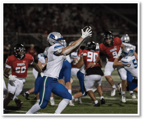 A football player is kicking a football on a field. Description generated by AI