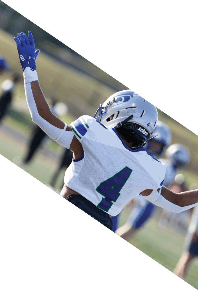 Four football players pose for a picture on the field. AI generated content
