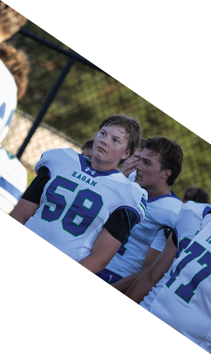 A group of football players pose for a picture. AI generated content