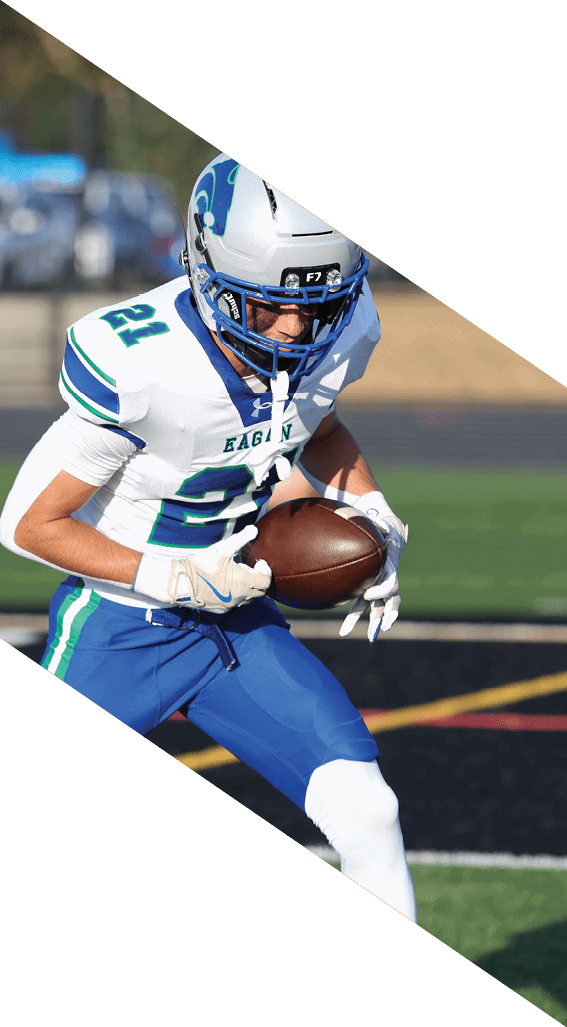 A football player wearing a black helmet and white jersey is holding a football in his hands. AI generated content