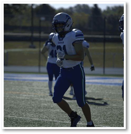 Two football players wearing black jerseys with the number 11 on them. Description generated by AI