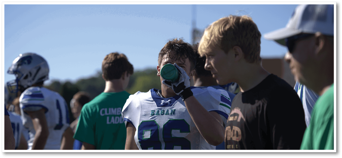A group of football players on a field. Description generated by AI