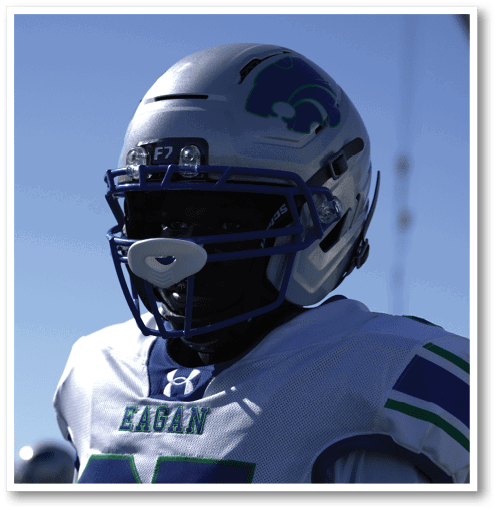 A group of men wearing black and white jerseys. Description generated by AI