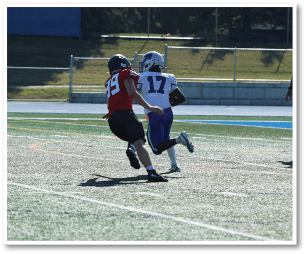 A group of football players wearing black jerseys with the number 3 on them. Description generated by AI