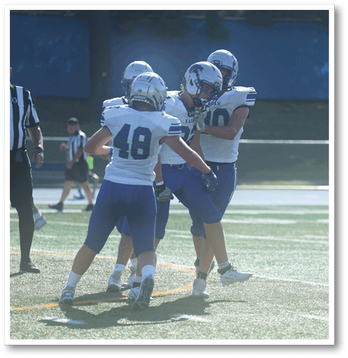 Two football players wearing black jerseys with the number 11 on them. Description generated by AI