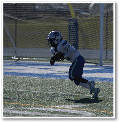 A football player wearing a black jersey with the number 6 on it. Description generated by AI