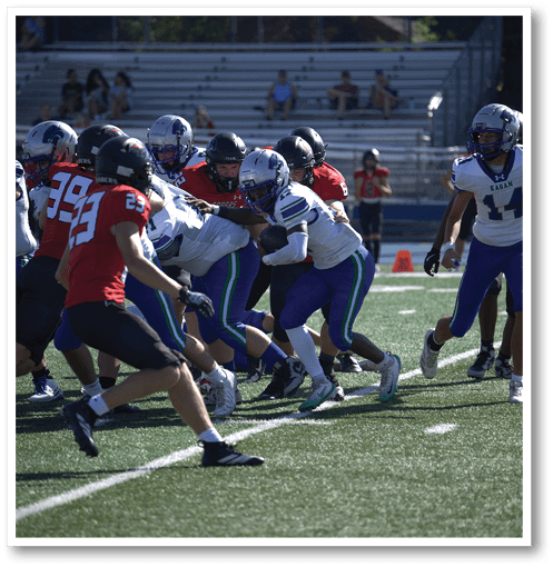 A football player wearing a black jersey with the number 6 on it. Description generated by AI