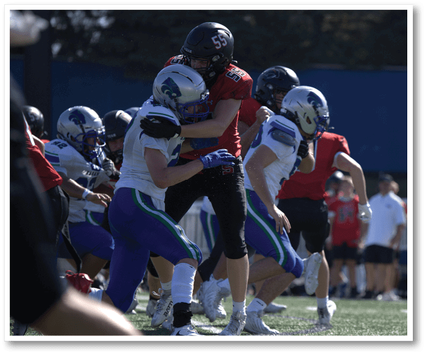 A football player is kicking a football on a field. Description generated by AI