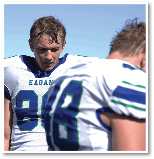 Two football players wearing black jerseys with the number 11 on them. Description generated by AI
